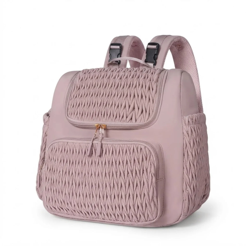 Vue du sac à langer à poches isothermes en coloris rose poudré, trois-quarts, sur fond blanc.